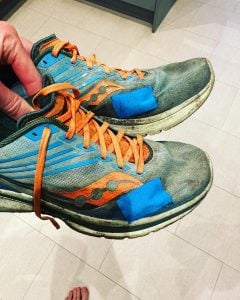 A Pair of Running Trainers with A Patch to Fix A Hole