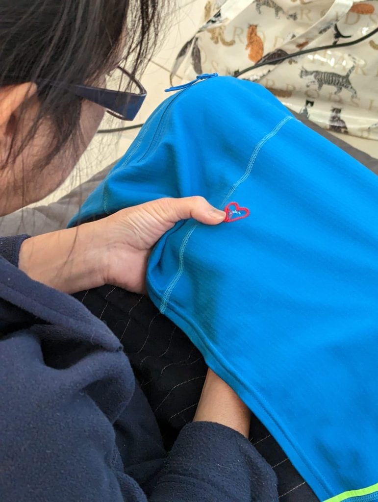 A Lady Repairing A Broken Jacket