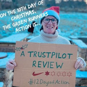 Lady holding up a cardboard sign for the 12 days of action campaign