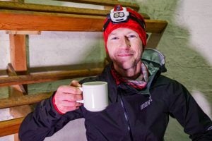 Damian Hall Looking at the Camera Holding Up a Cup of Tea