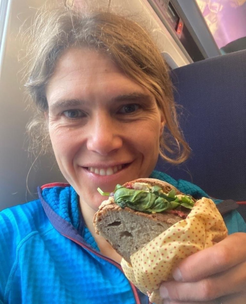 Jasmin Paris eats a veggie sandwich on a train