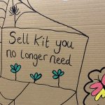 A cardboard sign at a convention with the words 'Sell kit you no longer need' on it