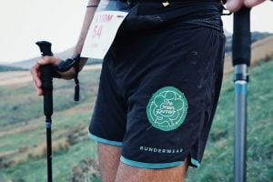 Photo of a runner's shorts with a Green Runners patch stitched on to them