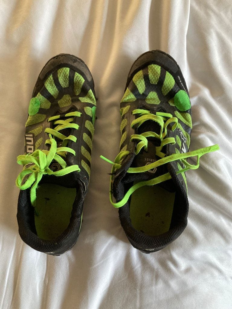 Jasmin's shoes from the Barkley Marathon, sporting green patches from where she has repaired them