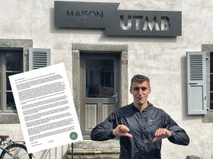 Our co-founder Ajay outside the UTMB HQ handing in our open letter. He's pulling a face and pointing his thumbs down.