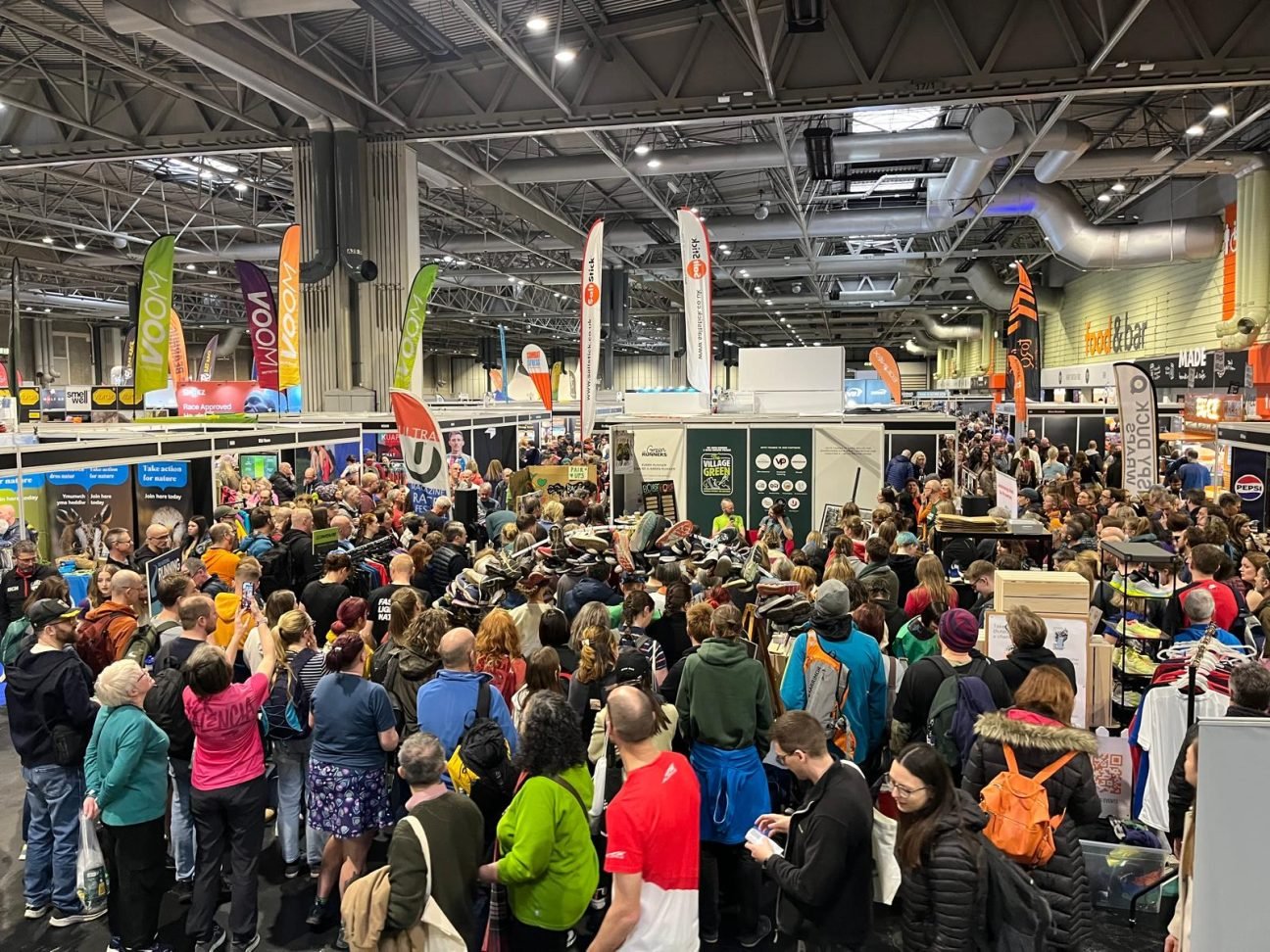 Visitors gather at the Village Green hosted by The Green Runners at the 2025 National Running Show