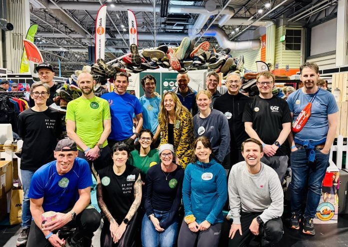 The Green Runners under the arch of used trainers at the 2025 National Running Show